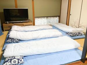 a room with three pillows and a flat screen tv at Oyado Nagomi - Vacation STAY 29876v in Takamatsu