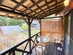 a screened in porch with a table and chairs at Oyado Nagomi - Vacation STAY 29876v in Takamatsu