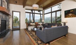 a living room with a couch and a fireplace at Silvertip Cabin 16 Alpine Bend in Big Sky