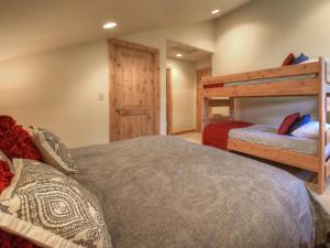 a bedroom with two beds and a bunk bed at Black Eagle 32 in Big Sky