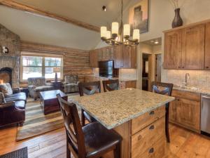 una cucina e un soggiorno con una grande isola in una casa di Cowboy Heaven Cabin 15 Derringer a Big Sky