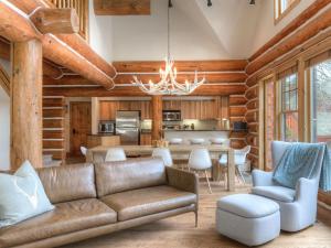 a living room with a couch and a table at Powder Ridge Cabin Rosebud 24 in Big Sky