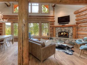 a living room with a couch and a fireplace at Powder Ridge Cabin Rosebud 24 in Big Sky