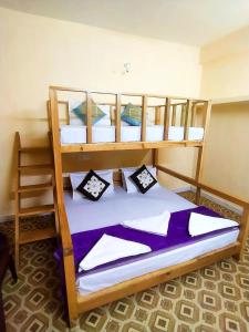a bedroom with two bunk beds in a room at Orange sky home stay gadaGushaini near jibhi in Jibhi