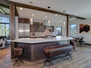 a kitchen with a large island with a counter top at Homestead Chalet 6 Claim Jumper in Big Sky