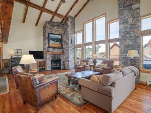 a large living room with a stone fireplace at Black Eagle 31 in Big Sky