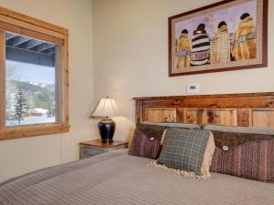 a bedroom with a bed and a window at Black Eagle 31 in Big Sky