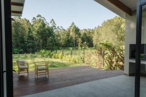 two chairs and a table on a wooden deck at 21 Heather Road in George