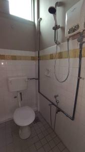 a bathroom with a toilet and a shower in it at Jabez Resort Kundasang in Kundasang