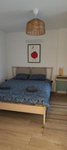 a bedroom with a bed with a blue comforter at POMODORO ROOMS in Zagreb