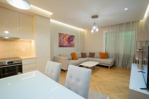 a kitchen and living room with a couch and a table at Center Tirana Liv apartment in Tirana