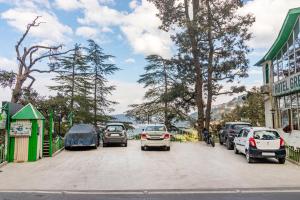 une rue avec des voitures garées sur le côté de la route dans l'établissement Treebo Trend Greenland - Mall Road, à Shimla