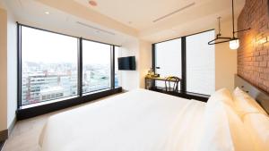 Postel nebo postele na pokoji v ubytování CHECK inn Taipei Songjiang