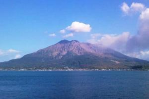 a mountain in the middle of a body of water at カナン中央町A館 in Kagoshima