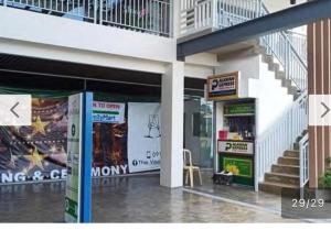 a building with a balcony and a store front at Antara Condominium Residences in Talisay