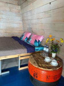 a room with a bed and a table in it at Homestay Hoa Núi in Cam Ranh