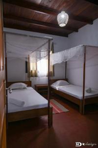two bunk beds in a room with a ceiling at tsarajoro in Mahajanga