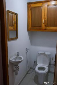 a bathroom with a toilet and a sink at tsarajoro in Mahajanga