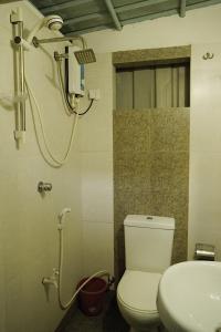 a bathroom with a shower and a toilet and a sink at City View Hostel in Kandy