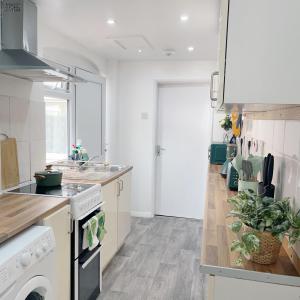 a kitchen with a sink and a stove top oven at Monk's Lodge Private En-suite Room CV1 in Parkside