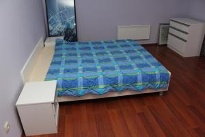 a bedroom with a bed with a blue blanket on it at Vile Plehan in Derventa
