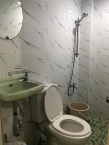 a bathroom with a toilet and a sink at THE MANSION - 2 PAX SOLO BUDGET Room near AIRPORT TERMINAL in Manila