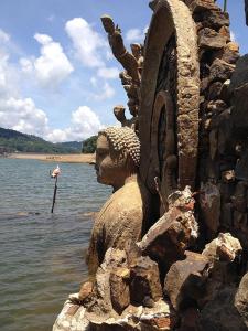 a statue sitting on the shore of a body of water at ROYAL MOUNT HOTEL in Gampola