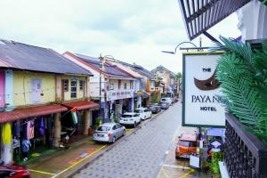 a city street with cars parked on the street at The Payang Hotel in Kuala Terengganu