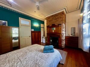 a bedroom with a bed and a fireplace at Minto Accommodation Brisbane in Brisbane