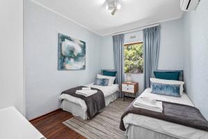 a hotel room with two beds and a window at San Lameer Villa 12405 - 2 Bedroom Classic - 4 pax - San Lameer Rental Agency in Southbroom +34 photos