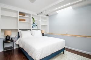 een slaapkamer met een groot bed en witte planken bij Charlestown 2br w in-unit wd close to dining BOS-962 in Boston