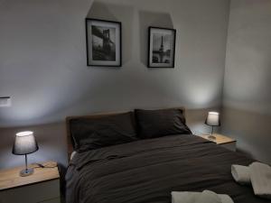 a bedroom with a bed and two lamps on two tables at Cà Fiamma in Casale Monferrato