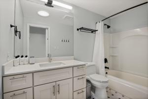 a white bathroom with a sink and a toilet at Bellevue 2br close to state park restaurants SEA-686 in Bellevue +17 photos