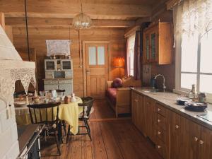 a kitchen with a table and a dining room at Aczarowane Kojły 7 in Kojły