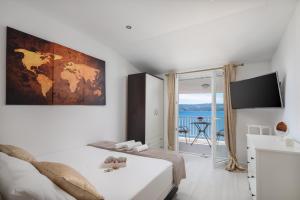 Un dormitorio con una cama y vista al mar. en Luxury Seafront Villa with Heated Pool, Jacuzzi, Sea View, 150 m from Beach, en Stanići