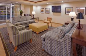 uma sala de estar com sofás e uma televisão em Candlewood Suites Kansas City Northeast, an IHG Hotel em Kansas City