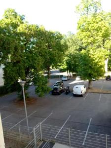 a parking lot with cars parked in it at Studio des Thermes 2* in Vittel +5 photos