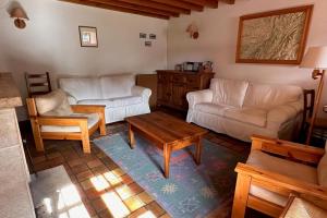 a living room with two couches and a coffee table at Le Nid de Pajonnière en chartreuse in Saint-Pierre-de-Chartreuse