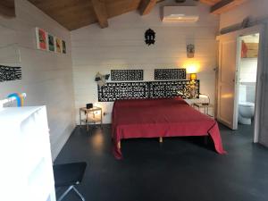 a bedroom with a bed with a red blanket at Miniglamp E.V. - Camping in Ischia