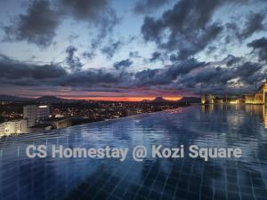 a swimming pool on top of a building with a city skyline at CS Homestay at Kozi Square Kuching in Kuching