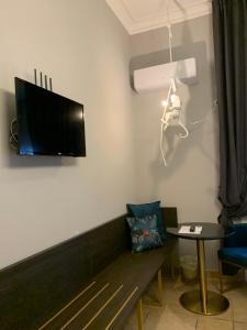 a living room with a couch and a flat screen tv at Spazio SIMA Space 2 - 1 in Milan