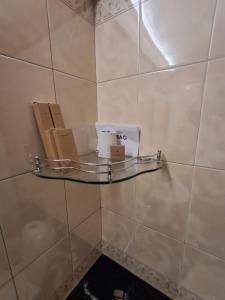 a shelf on a tiled wall with boxes on it at Presidency Towers,Kochi in Cochin