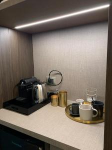 a kitchen counter with a coffee maker and coffee cups at Spazio SIMA Space 2 - 1 in Milan