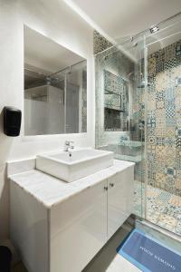 a white bathroom with a sink and a shower at Designer Baron Palace 4BR Garden Duplex in Cairo