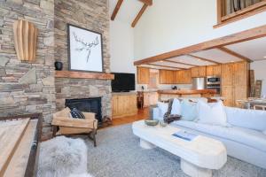 a living room with a couch and a fireplace at Black Eagle 12 in Big Sky