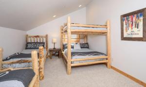 a bedroom with two bunk beds in a house at Black Eagle 12 in Big Sky