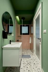a bathroom with a white sink and a mirror at Designer Baron Palace 4BR Garden Duplex in Cairo