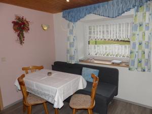 a dining room with a table and chairs and a window at Ferienunterkünfte Kreißl Oberwiesenthal in Kurort Oberwiesenthal