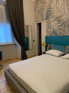 a bedroom with a large white bed and a mirror at Spazio SIMA Space 2 - 2 in Milan