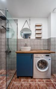 a bathroom with a washing machine and a sink at Kudebi apartments, Twins new Gudauri in Gudauri +83 photos